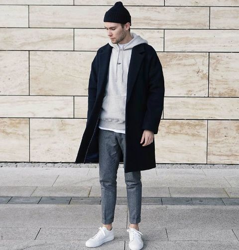 With black coat, gray trousers, white sneakers and beanie