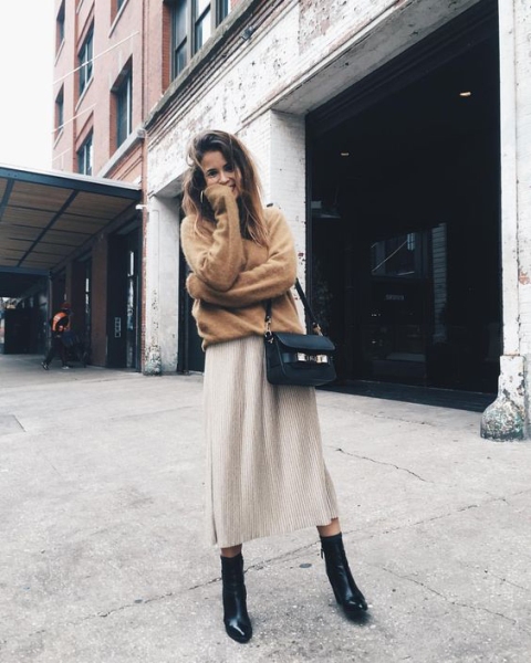With brown sweater, beige midi skirt and black small bag