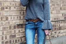With distressed jeans, brown belt, sunglasses, brown suede boots and chain strap bag