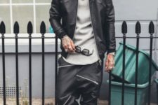 With gray long shirt, black leather jacket and sneakers
