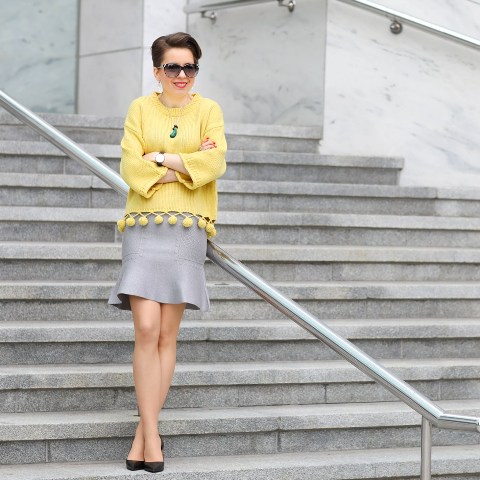With gray skirt, black high heels and sunglasses