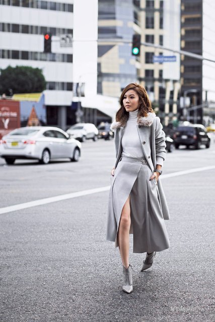 With gray turtleneck, gray midi coat and gray leather ankle boots