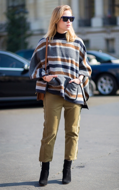 With olive green crop pants, brown bag and black suede boots