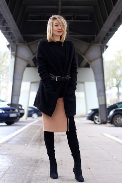 With over the knee boots, black sweater, black cardigan and belt