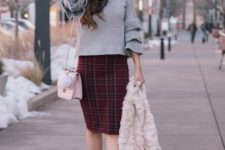 With plaid skirt, pastel colored bag, black ankle boots and fur jacket