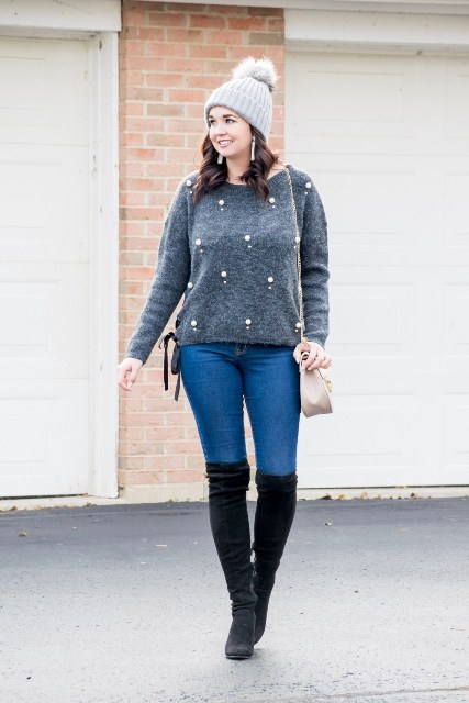 With pom pom hat, skinny jeans, black suede over the knee boots and beige bag