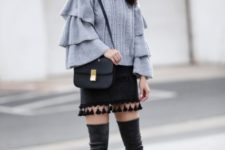 With tassel skirt, black bag and dark gray boots