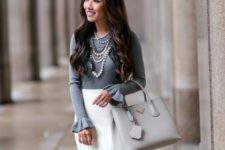 With white pencil skirt and light gray bag