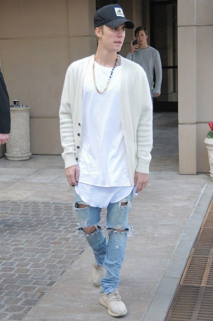 With white t-shirt, beige cardigan, cap and distressed jeans