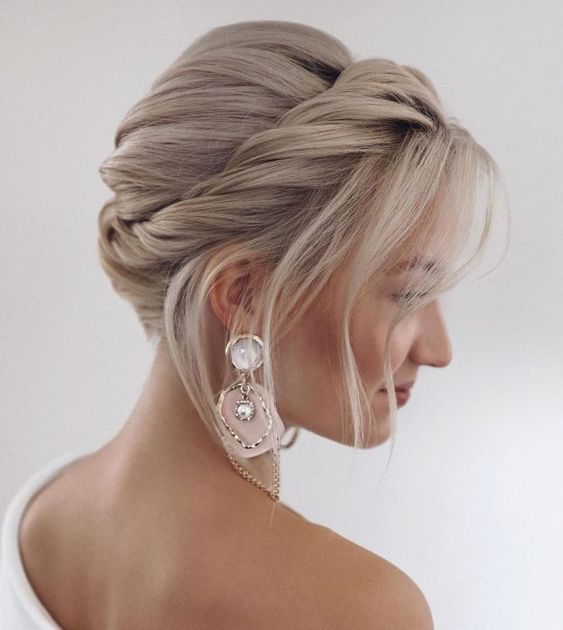 a Christmas updo with a twisted halo and a bump on top plus some face-framing locks is a lovely idea for medium hair