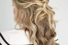 a beautiful messy twisted and wavy half updo with a bump on top and some face-framing locks is amazing for a holiday party