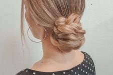 a braided low bun with a sleek top and face-framing hair is a catchy and cool solution for a Christmas party