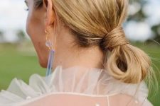 a casual low knot updo with a messy top is a cool idea for a modern or minimalist look