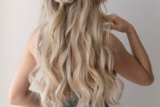 a classy half updo with a volume on top, waves and a loose braid is a beautiful idea for both long and medium hair