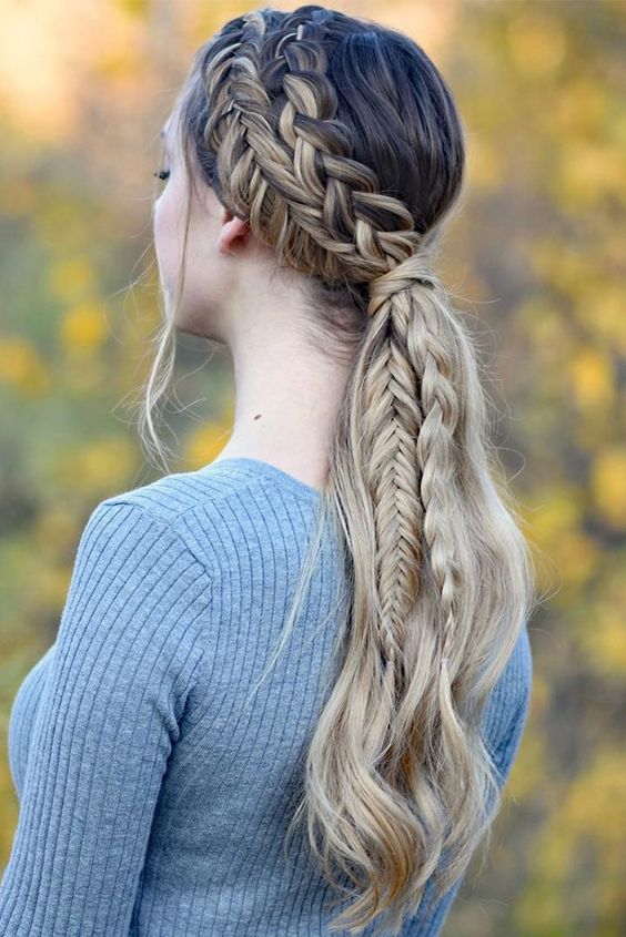 a creative braided ponytail with a double side braid and waves down is a cool idea for a boho party look