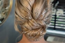 a fantastic twisted updo with a lot of volume and silver glitter right on the hair is a wow solution for the holidays