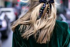 a half updo with a volume on top and a black bow accented with colorful rhinestones will be a lovely idea for the holidays