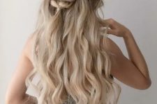 a half updo with a wavy top, a braided touch and waves down is a cool idea for a catchy look