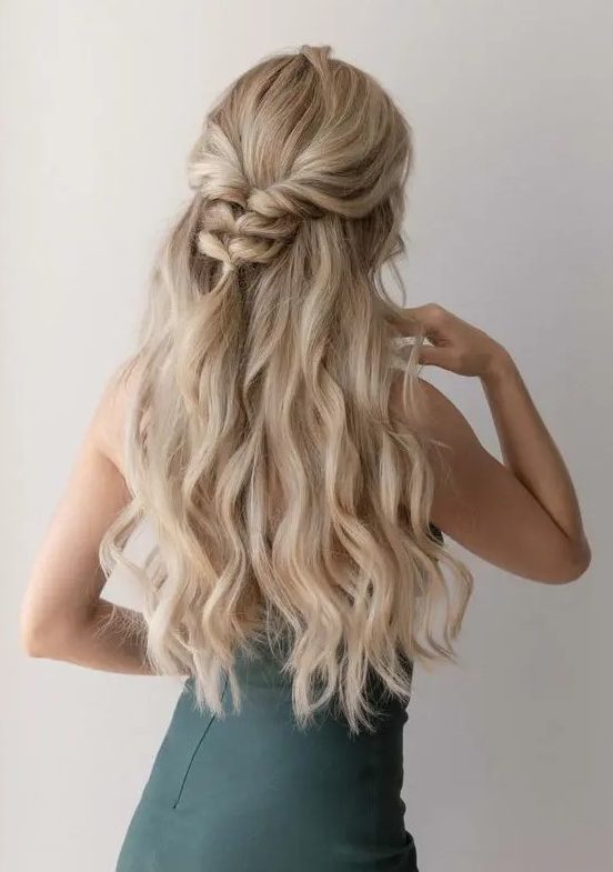 a half updo with a wavy top, a braided touch and waves down is a cool idea for a catchy look