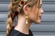 a long loose braid paired with a fantastic rhinestone tiara in Christmassy colors and statement earrings