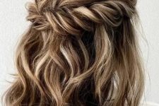 a lovely and pretty wavy half updo with a bump on top ,a twisted looped halo and waves down is a cool idea for medium length hair