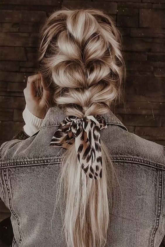 a lovely loose chunky braid with a ponytail, volume on top and a printed ribbon is a cool and easy hairstyle
