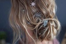 a lovely low bun with a messy wavy top, some locks down and beautiful celestial hair pins