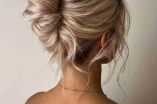 a lovely messy and twisted chignon hairstyle with a messy wavy top and some locks down is a lovely idea