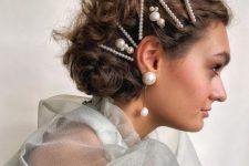 a lovely wavy half updo with multiple pearl bobby pins and statement pear earrings is wow