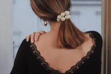 a medium low ponytail with a pearl scrunchie is a catchy and romantic idea for the holidays