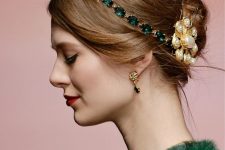 a messy Christmas updo with a volume on top and a bold green rhinestone headband plus a pearl hair pin is amazing
