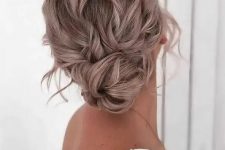 a messy and wavy low bun with a wavy top, some face-framing locks and a twisted low bun is cool and catchy