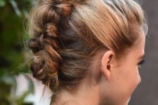 a messy braided updo with a volume on top is a cool and catchy idea if your hair is long enough