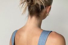 a messy double top knot with a sleek top and some hair is a cool and catchy solution for those who have medium to long hair