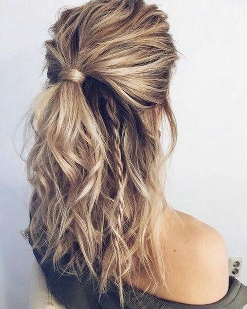 a more casual and messy half updo with a messy wavy top, a wavy ponytail and some little braids is a cool idea for a casual holiday look