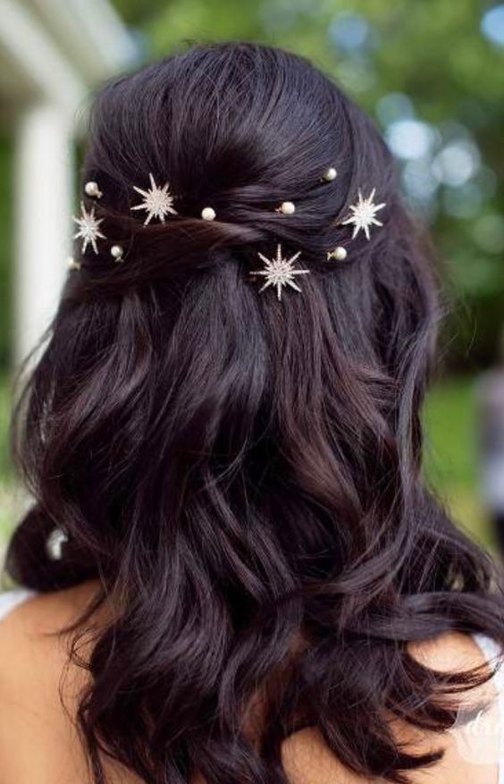 a pretty half updo with twists, waves down and pearls and stars is a fantastic idea to look dreamy at the party