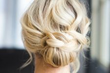 a pretty low updo with a braided touch and a wavy and mess top is a cool solution for a Christmas look