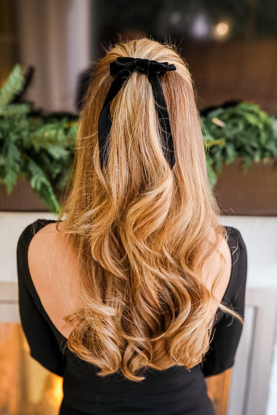 a sexy half updo with waves and volume plus a black velvet bow is always a perfect solution for Christmas