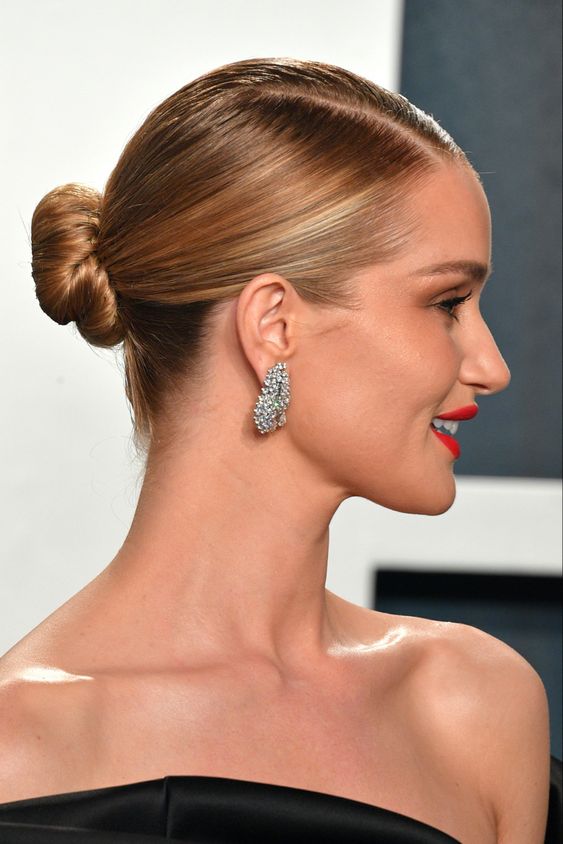 a sleek bun with a slee top and parting is a cool and catchy idea that looks timeless and elegant