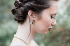 a stylish braided halo updo with a low bun and volume on top is a cool and chic idea for a holiday party