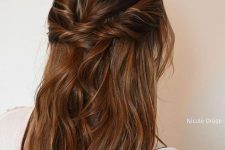 an elegant long half updo with twists on top and sides and waves down is a cool idea for a holiday party