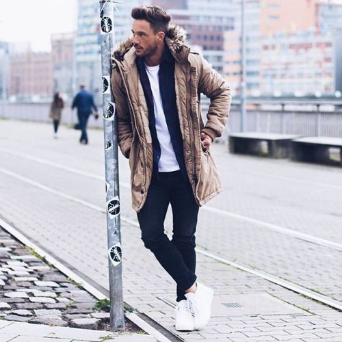 black jeans, a white tee, a black cardigan, white sneakers and a camel puffer coat with fur