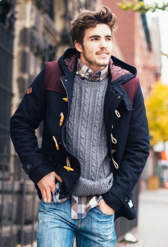 blue jeans, a plaid shirt, a grey cable knit sweater, a navy and burgundy coat with a hood
