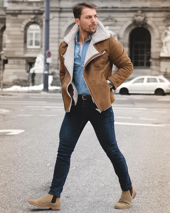 navy jeans, a white tee, a denim shirt, beige boots and a camel shearling coat
