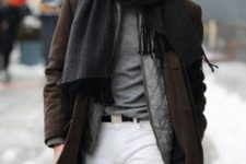 white jeans, a grey tee, a grey quilted vest, a brown coat, a grey scarf and a green hat