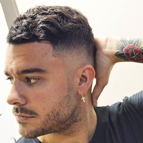 short and thick wavy hair on top and a high bald fade is a trendy option with an accent on your waves
