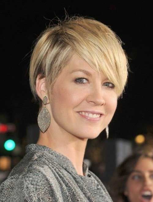 a longer pixie haircut with bangs and a slight balayage looks very elegant and sassy