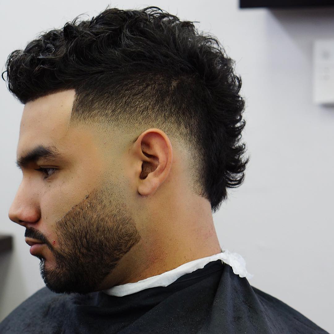 A mohawk fade on curly hair requires minimal effort to style and works no less cooler than with straight hair