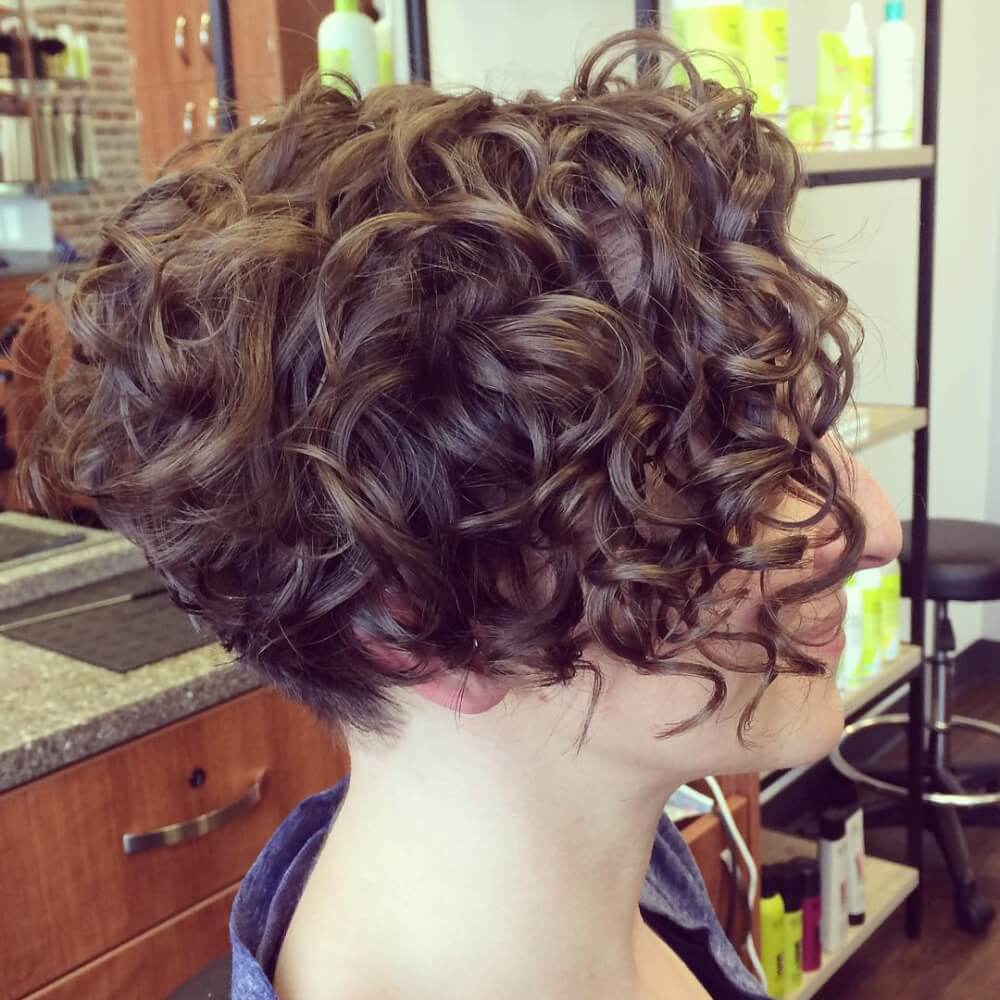 a naturally curly angled short bob doesn't require much maintaining and looks dimensional