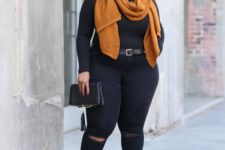 black ripped skinnies, a black turtleneck, a rust scarf and rust lace up shoes plus a black clutch